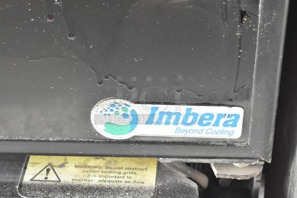 Imbera G319 metal commercial cooler logo detail with warning label visible. 115 volts, 1 phase, includes poly-coated racks.