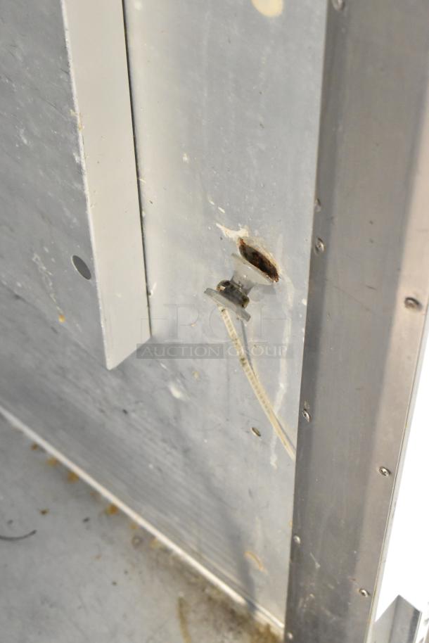 Traulsen G30010 cooler interior detail showing wiring and panel edge. Some wear visible on the metal surface.