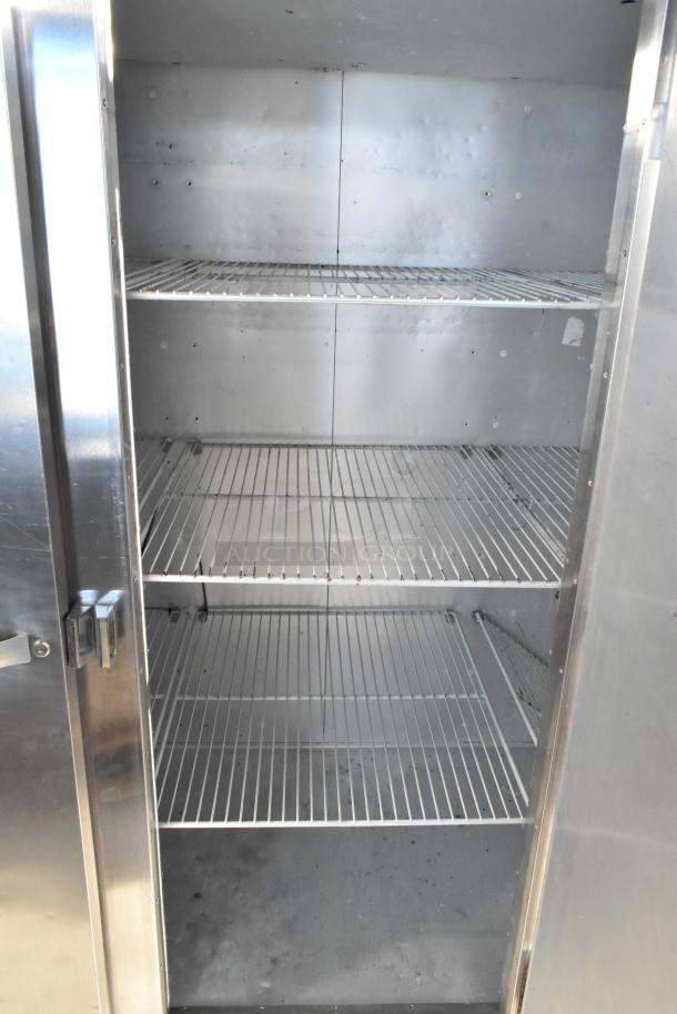 Traulsen G30010 stainless steel 3-door commercial cooler with racks, 115V, 1 phase, excellent condition.