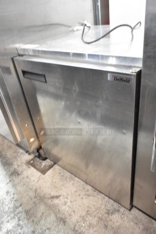 Delfield 406CA-DD1 stainless steel undercounter cooler, single door, on commercial casters, visible Delfield logo.