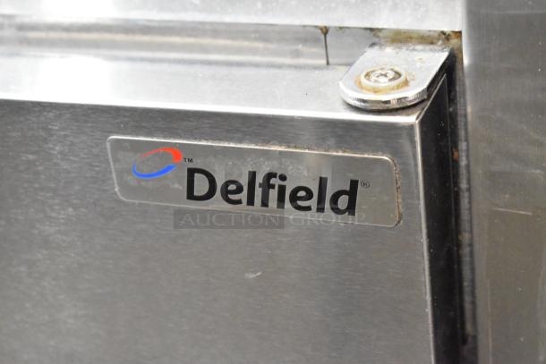 Delfield 406CA-DD1 stainless steel undercounter cooler, single door, on casters, 115V, features Delfield logo.