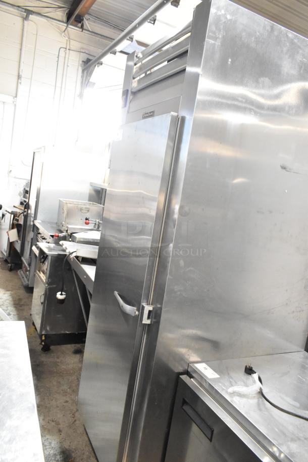 2016 Traulsen AHT132WUT-FHS stainless steel single door reach-in cooler, commercial casters, 115V, 1 phase, visible racks.