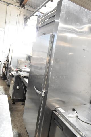 2016 Traulsen AHT132WUT-FHS stainless steel single door reach-in cooler, commercial casters, 115V, 1 phase, visible racks.