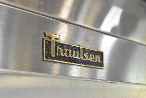 2016 Traulsen AHT132WUT-FHS stainless steel cooler, single door, with logo. Features racks, commercial casters, 115V, 1 phase.