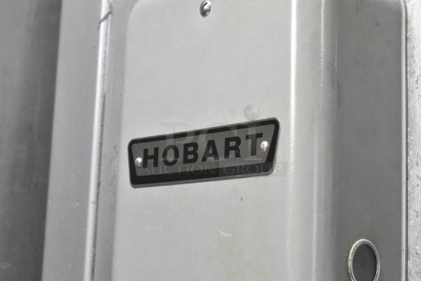 Hobart 5614 metal commercial floor-style meat saw, 200-230V, 3-phase, featuring a visible Hobart logo on the casing.