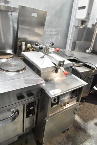 Henny Penny stainless steel commercial electric pressure fryer on casters, 220V, 3 phase, visible controls, clean condition.