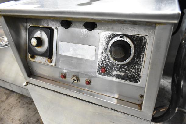 Henny Penny stainless steel electric pressure fryer on casters, 220V, 3-phase. Shows control panel with wear and markings.