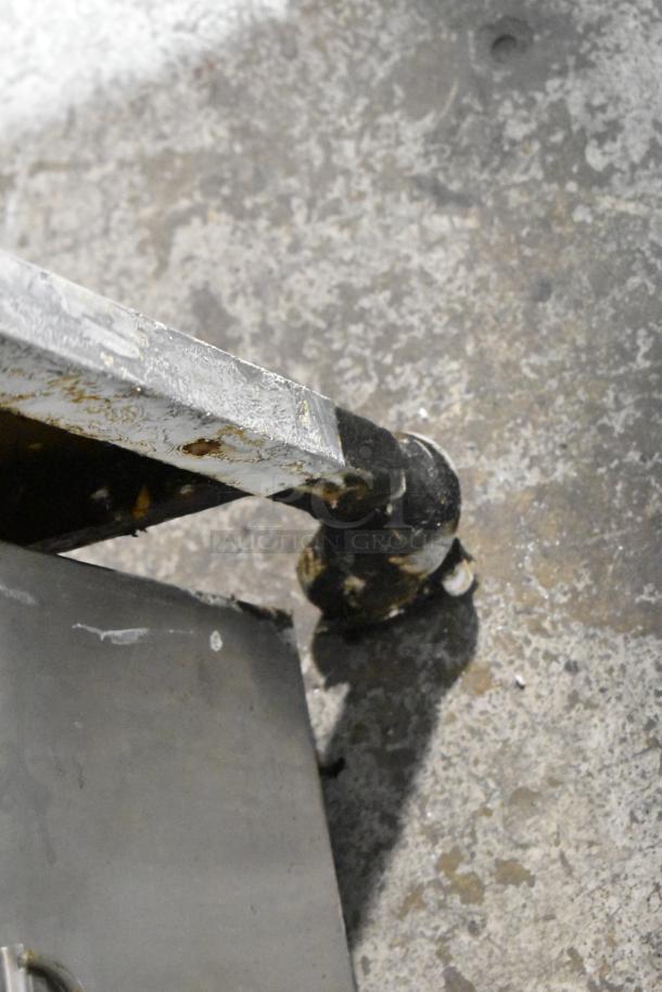 Henny Penny stainless steel pressure fryer on industrial casters, 220V, 3-phase. Suitable for commercial kitchens. Visible wear.