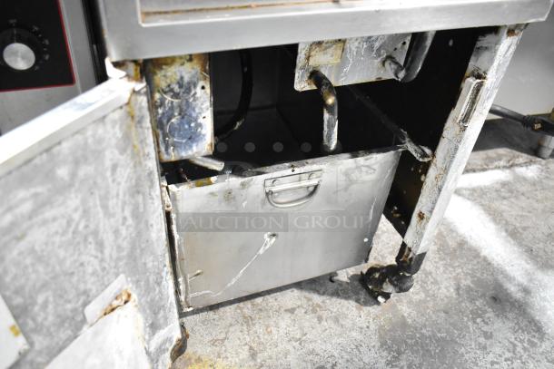 Henny Penny stainless steel commercial electric pressure fryer, floor style, on casters, 220V, 3 phase, worn condition.