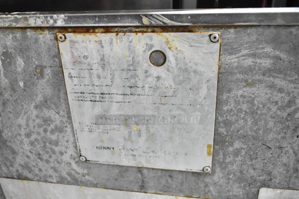 Henny Penny stainless steel electric pressure fryer on casters. Visible wear and rust. Rated 220V, 3 Phase. Manufacturer's plate attached.