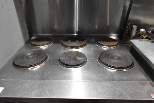 Cookline stainless steel 6-burner hot plate range with oven, over shelf, and backsplash; used, good condition.