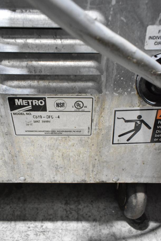 Metro C519-CFC-4 heated holding cabinet, metal construction, on commercial casters. Model and safety labels visible.