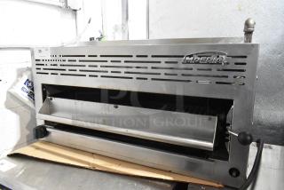 Imperial Stainless Steel Commercial Gas Cheese Melter, slightly used, featuring vented design and manual lever, model visible.