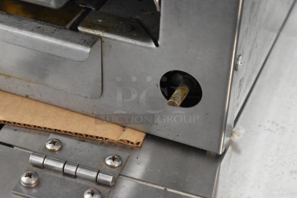 Imperial stainless steel commercial cheese melter, gas-powered, visible hinge and burner, used condition, auction item.