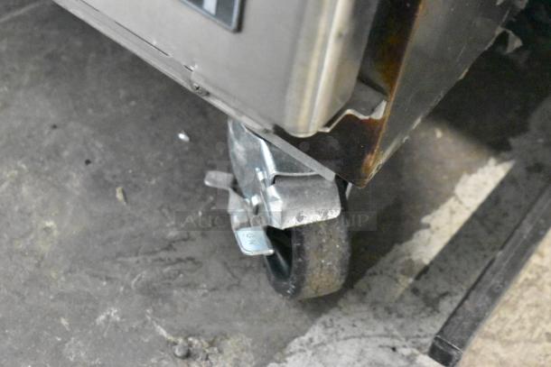 Everest ETBR1 stainless steel single door cooler on commercial casters, showing caster detail. 115V, 1 phase.