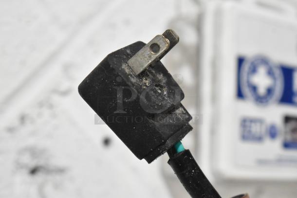 Close-up of a dusty electrical plug, suitable for the Everest ETBR1 cooler. Plug shows wear but is intact.