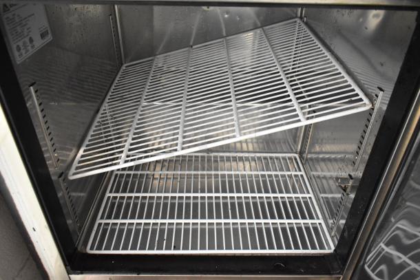 Everest ETBR1 stainless steel commercial single door cooler, interior view with wire shelves, on commercial casters.
