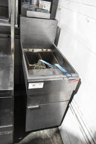 Stainless steel commercial deep fat fryer with 2 metal fry baskets, floor style. Features visible American flag sticker and auction tag.