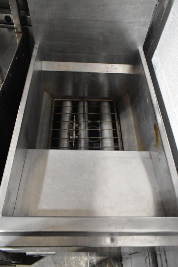 Stainless steel commercial deep fat fryer in good condition, featuring two metal fry baskets, ideal for high-volume cooking.
