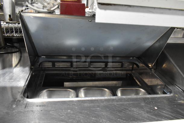 Delfield UCD4464N-12-DD5 stainless steel sandwich salad prep table with bain marie top, 4 drawers, and overshelf.