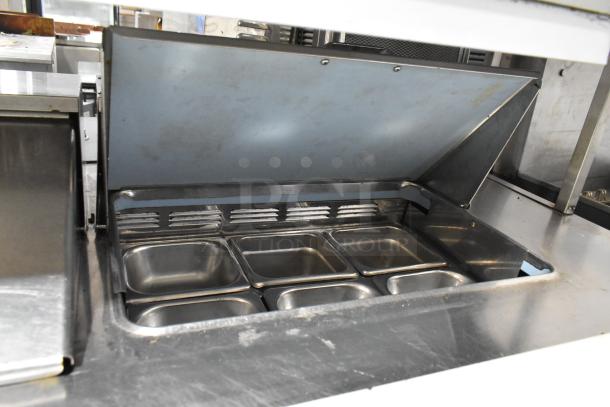 Delfield UCD4464N-12-DD5 stainless steel prep table with bain marie top, 4 drawers, over shelf, and visible interior pans.