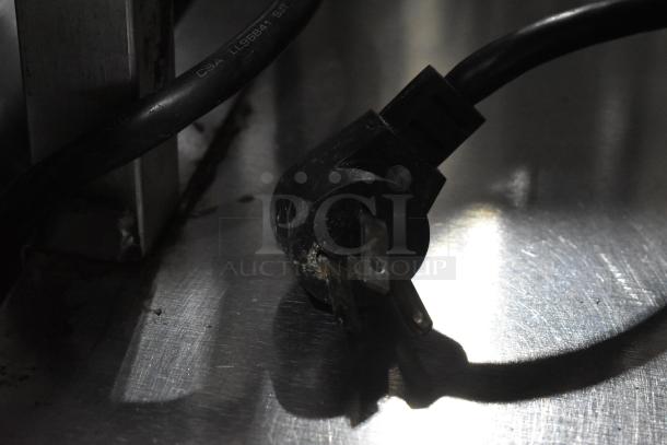 Close-up of power plug for Delfield UCD4464N-12-DD5 Stainless Steel Prep Table, showing standard three-prong design.