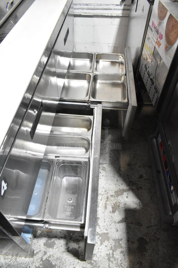 Delfield UCD4464N-12-DD5 stainless steel prep table with 4 drawers, over shelf, and bain marie mega top. 115V, 1 phase.