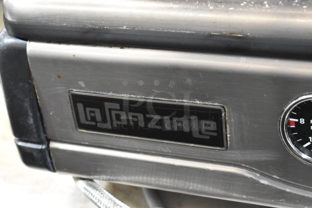 La Spaziale stainless steel commercial espresso machine with portafilter, steam wand, and logo plate visible.