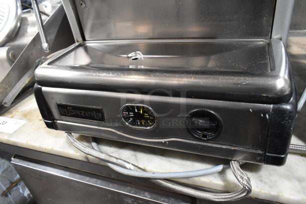 La Spaziale stainless steel commercial single group espresso machine with portafilter and steam wand, visible pressure gauge.