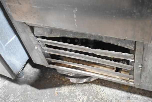 Leader LB72 stainless steel 3-door work top cooler. Features include commercial casters and 115V, 1-phase power. Condition shows visible wear.