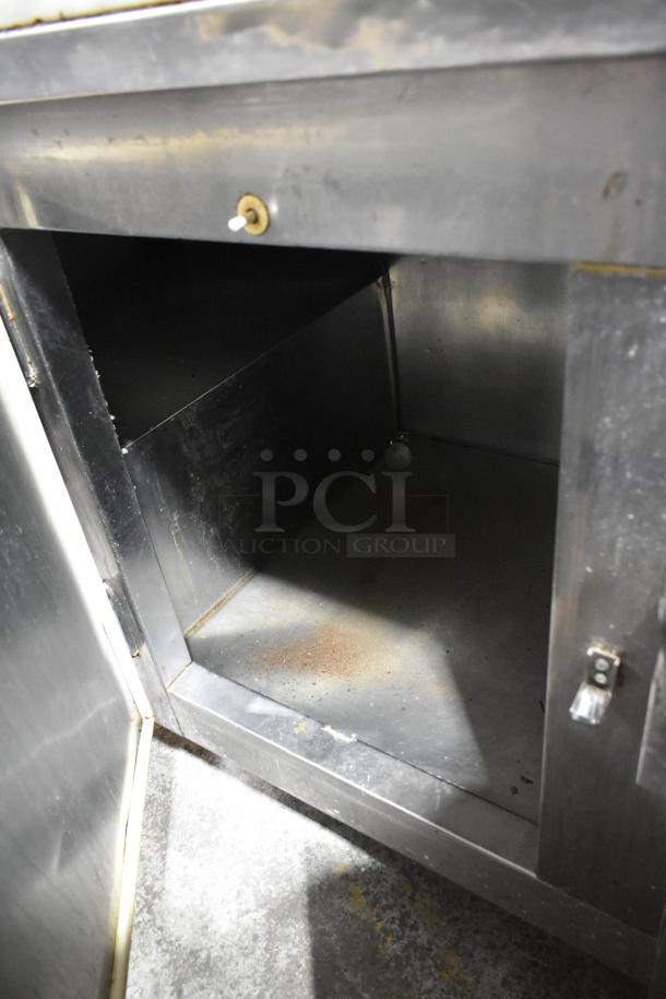 Leader LB72 stainless steel commercial 3-door work top cooler, interior view. Features casters, 115V, 1 phase. Signs of wear.