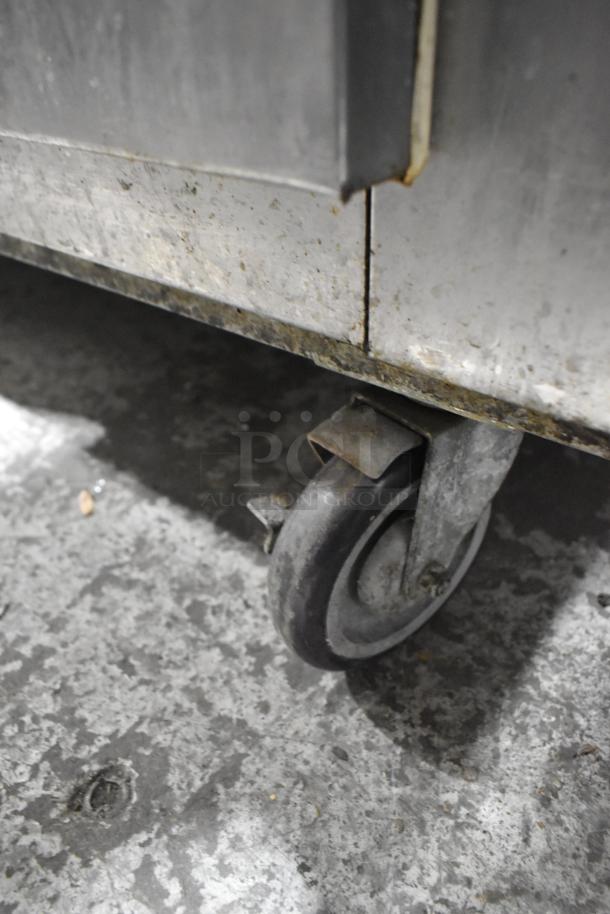 Leader LB72 stainless steel 3-door cooler on commercial casters, visible wear. Model LB72, 115 volts, 1 phase.