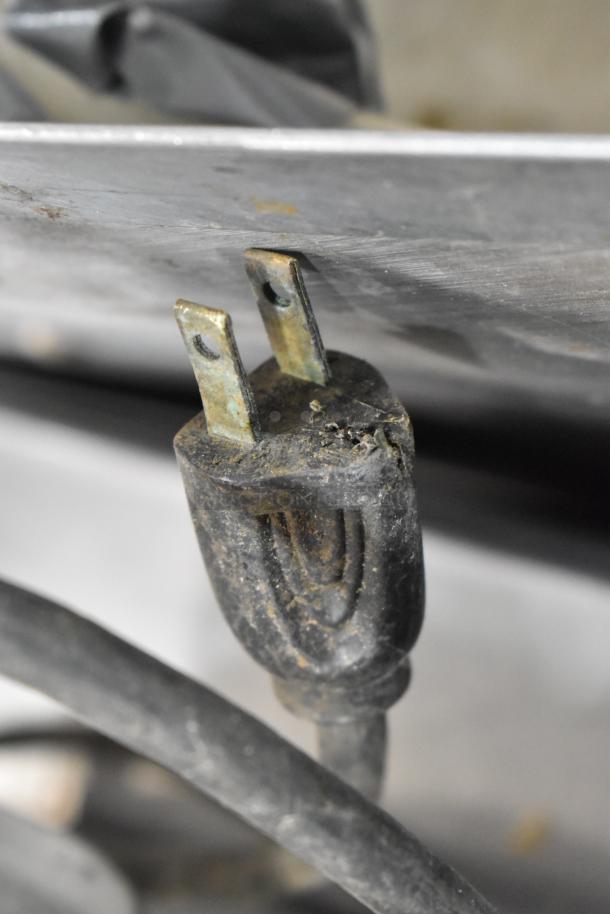 Close-up of a worn plug for Globe 500 Stainless Steel Meat Slicer, 115 Volts, 1 Phase.