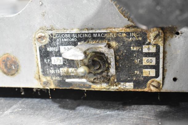 Globe 500 Stainless Steel Commercial Meat Slicer, 115 Volts, 1 Phase, in used condition with visible label details.