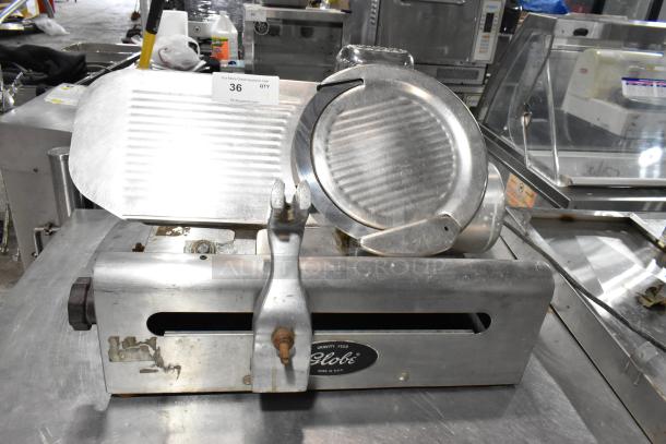 Globe 500 stainless steel commercial meat slicer with blade sharpener, missing carriage, 115 volts, 1 phase.