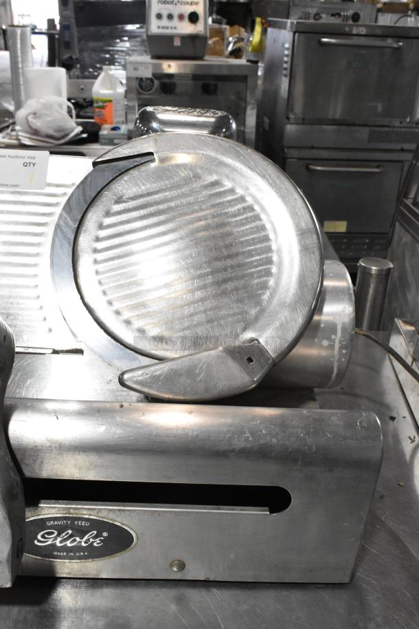 Globe 500 stainless steel commercial meat slicer with blade sharpener, missing carriage, 115V, 1 phase.