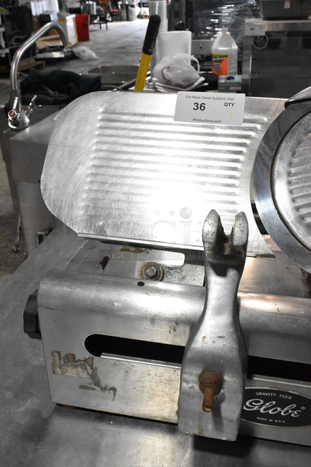 Globe 500 stainless steel commercial meat slicer, includes blade sharpener, missing carriage, 115 volts, 1 phase.