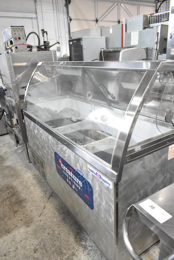 Metal commercial ice cream dipping cabinet with bucket collars, featuring branded signage. Good condition, ideal for retail.