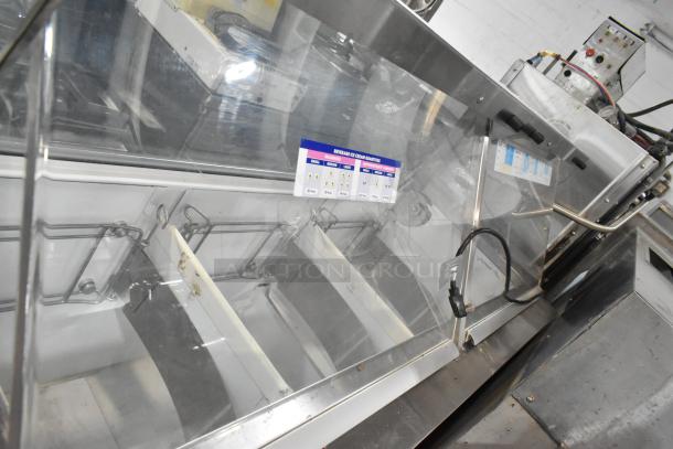 Metal commercial ice cream dipping cabinet with bucket collars, featuring a glass display, power cord, and capacity label.