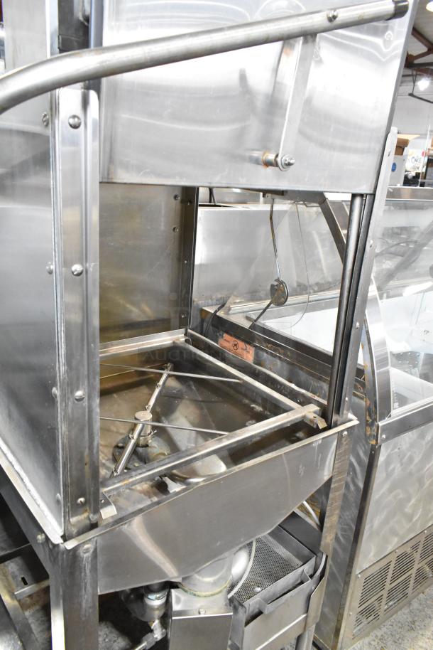 American Dish Service stainless steel corner pass-through dishwasher. 120V, 1 phase. Features visible washing arms. Good condition.