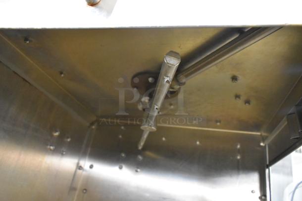 American Dish Service ADS stainless steel commercial corner pass-through dishwasher interior, showing spray arm in good condition.