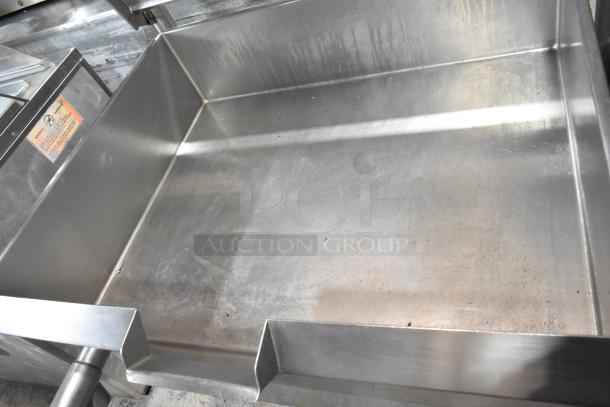 Cleveland stainless steel commercial braising pan, floor style. Appears in used condition with minor wear. Safety label visible.