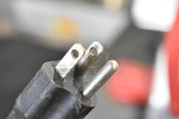 Close-up of a three-prong plug for the Berkel 825A-PLUS meat slicer. Visible markings show 115 volts, 1 phase.