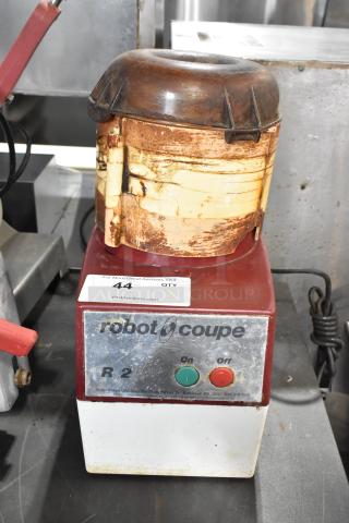 Robot Coupe R2 metal countertop food processor with bowl, lid, 2 grating blades, and slicing blade. 120 volts, used condition.