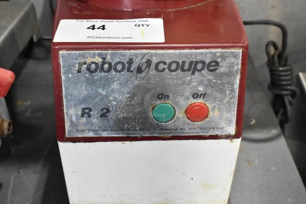 Robot Coupe R2 countertop food processor with bowl, lid, two grating blades, and slicing blade. 120V, used condition.