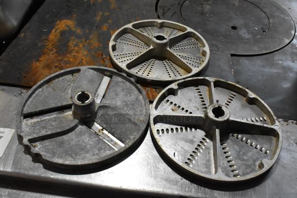 Robot Coupe R2 food processor blades; includes two grating blades and one slicing blade, showing wear.