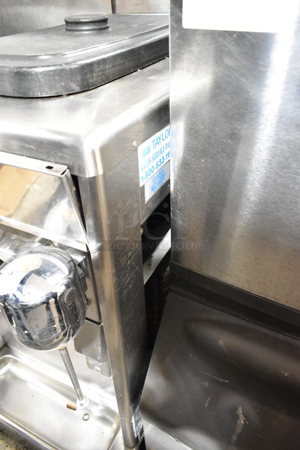 Taylor stainless steel commercial countertop single flavor frozen beverage machine with drink mixing attachment, 208-230V.