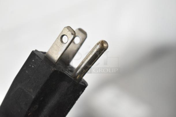Close-up of a standard 120-volt power plug for Narvon OASIS 2-10 slushie machine. Plug and prongs slightly worn.