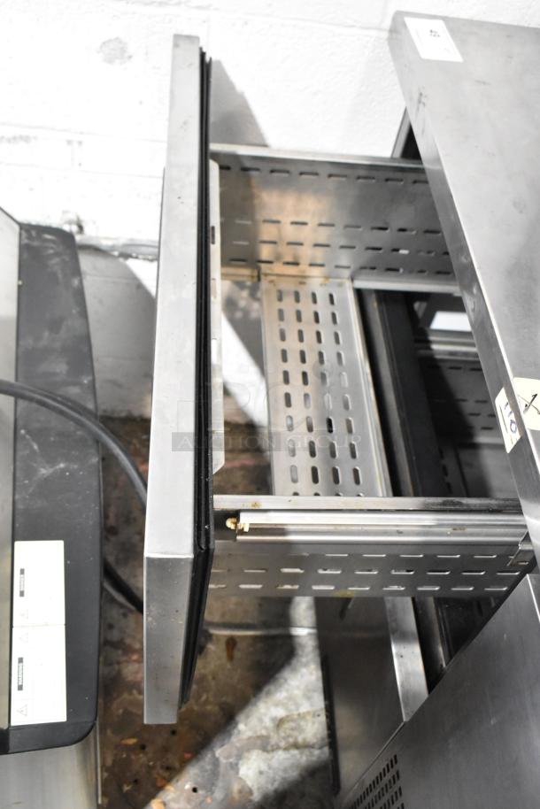 True stainless steel commercial undercounter cooler with 2 drawers on casters. 115 volts, 1 phase, well-maintained condition.