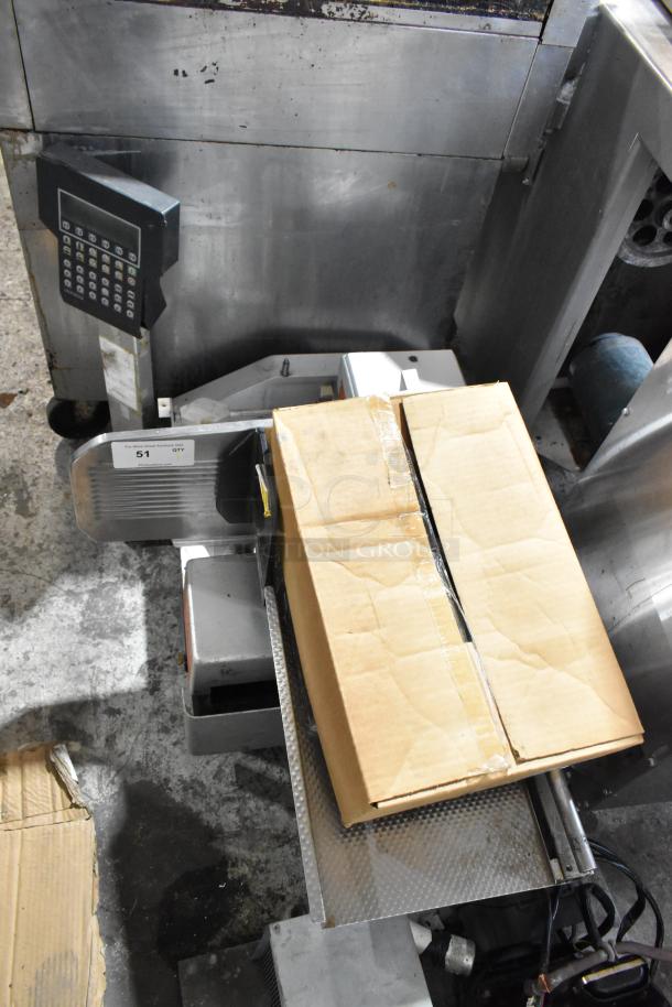 Bizerba metal commercial countertop meat slicer stacker in used condition with keypad, cardboard on top, and visible label.